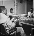 Steward's mates polishing silverware in the wardroom of the former aircraft carrier USS Ticonderoga (CV 14)