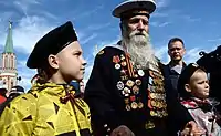 Georgy Shirokov, 91-year-old Russian veteran of World War II and former sailor of the Baltic Fleet walks with his great grandchildren