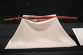 A hirumaki (leech patterned) katana mounting coated with vermilion lacquer and wrapped in a thin silver plate, Edo period, The Japanese Sword Meseum