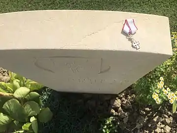 Miniature insignia of the Danish Dannebrog Order on Major Anders Lassen's gravestone at Argenta Gap War Cemetery, 1 September 2015. Text: "Gud og Kongen" - "God and the King".