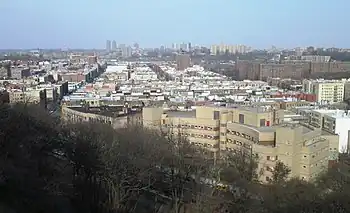 Overview of Inwood from Fort Tryon Park in 2018; in the right foreground is the Salome Urena de Henriquez Campus of the NYC Public Schools system; The Bronx is in the background