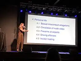 Annie Rauwerda standing on stage and pointing at "Personal life" section of Wikipedia page projected on screen