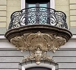Rococo Revival mascaron surrounded by shells and round shapes (aka volutes), on the facade of Strada General H. M. Berthelot no. 41, Bucharest, unknown architect, 1911