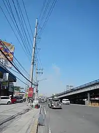 Steel pole 167 (using NAPOCOR-era steel pole 275 and of anchor or flag design) near Dolores Flyover in San Fernando, Pampanga. Originally located at the middle of Jose Abad Santos Avenue, the said pole was relocated at the edge of the road because it posed a safety hazard.