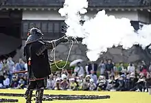 A member of the Matsumoto Castle Gun Corps firing a tan-zutsu.