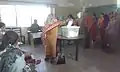 A female voter casts her ballot in a polling station in NA-250.