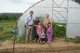 Arnaud Gouillon with his family from Kosovo and Metohija in front of a greenhouse donated by the French humanitarian organization "Solidarity for Kosovo"