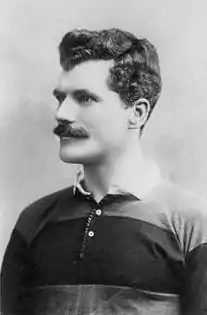 Arthur Gould wearing the black and amber hooped shirt of Newport RFC