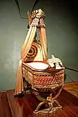 King of Rome's Cradle (Empire); by Pierre-Paul Prud'hon, Henri Victor Roguier, Jean-Baptiste-Claude Odiot and Pierre-Philippe Thomire; 1811; wood, silver gilt, mother-of-pearl, sheets of copper covered with velvet, silk and tulle, decorated with silver and gold thread; height: 216&nbsp;cm; Kunsthistorisches Museum (Vienna, Austria)