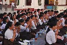 Image 18A group of Buddhist worshipers at Shwedagon Pagoda, an important religious site for Burmese Buddhists. (from Culture of Myanmar)