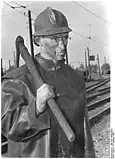 A brown coal miner with a pickaxe. West Germany, 1952