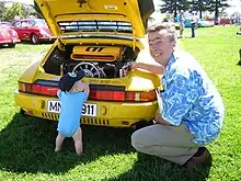 A view of the Ruf CTR engine bay of the CTR with Alois Ruf present near the car