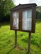 The village notice board which stands outside the boundary wall of the parish church of Our Lady and Saint Margaret.