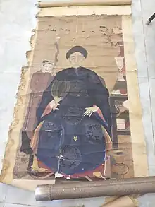 An old man holding a feather fan in the Nguyễn dynasty