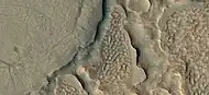 Close view of hollows formed when ice left the ground by sublimation. This was named a HiRISE picture of the day.