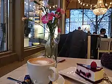 Image 19A cup of coffee with cheesecake at a cafe in Helsinki, Finland (from Coffee culture)