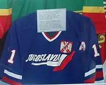 a blue jersey in a glass display case