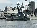 JS Yūdachi alongside JS Fuyuzuki and JS Hyūga at Yokosuka on 25 September 2017.