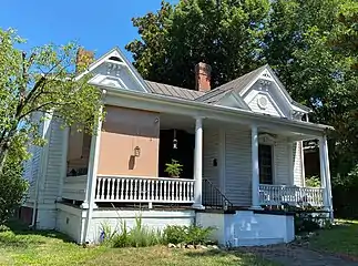 Danville North Queen Ann style home built in a gabled ell form during the late eighteen hundreds. It has original weatherboard siding. The veranda has spindle balusters and the window hoods have brackets.