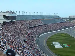 Auto-racing track with a large grandstand filled with spectators