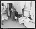Mr. Eddie Cain, Miner, Looking over his bills in his home, 1946