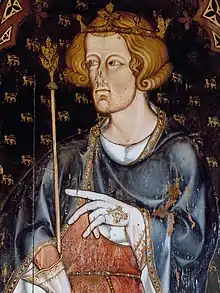 A man in medieval dress, wearing a crown and holding a sceptre.