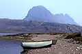Fionn Loch and Suilven. The path by the River Kirkaig leads to the shore of the Fionn Loch, where boats wait for anglers. The distinctive bulk of Suilven dominates the view.