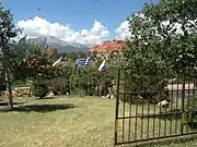 A circle of flags at the entrance to Garden of the Gods in Colorado, Springs, Colorado. The flags of the Russian Federation, the Hellenic Republic, and the Republic of China are visible in the foreground, just downhill from the gates to the parking lot.