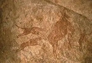 Image 30Petroglyph depicting two dogs hunting – Tassili n'Ajjer, Algeria (from Domestication of the dog)