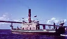 Vehicular ferry KOONDOOLOO final day of service 1971 with Stockton Bridge in the background