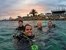 Happy SCUBA divers at Mossel Bay's Dolasse