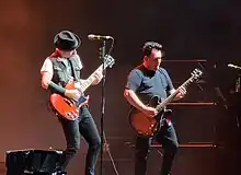 Goutzinakis (right) performing alongside Tom Thacker in 2023