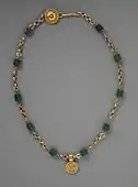 Necklace with a medallion depicting a goddess; 30–300 AD; green glass (the green beads) and gold; length: 43.82&nbsp;cm; Los Angeles County Museum of Art
