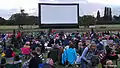 Inflatable air screen at Movies on the Meadows 2014 with audience and their picnics
