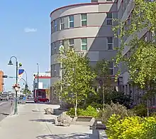 A view along the front of the building, in which we can see some of the street and buildings nearby in the background
