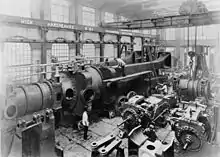 Under assembly c.1890, half of one of the two 10,000&nbsp;hp engines completed for Deptford Power Station at Hick, Hargreaves and Co. A travelling crane and hoist above.