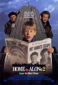 Kevin McAllister holding a newspaper with Marv and Harry behind him