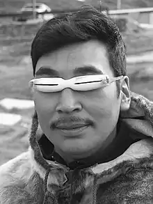 An inuit wearing snow goggles