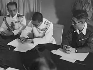 A Japanese Navy officer signing the surrender of Penang aboard HMS&nbsp;Nelson on 2 September 1945. Penang was liberated by the Royal Marines on the following day under Operation Jurist.