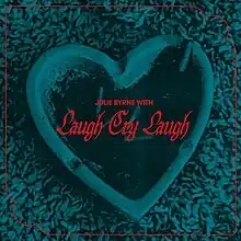 A dark teal-tinted photo of a heart-shaped ash trash on shag carpeting with a vermilion border