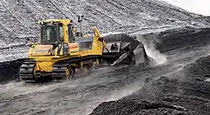 Bulldozer Komatsu D85 PX with semi-U tilt doze pushing coal on Power Station