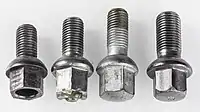 Four lug bolts, from left: Three M12x1.5&nbsp;mm bolts with different length and one M14x1.5&nbsp;mm bolt
