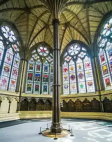 A large, octagonal room with stained-glass windows and a central pillar.