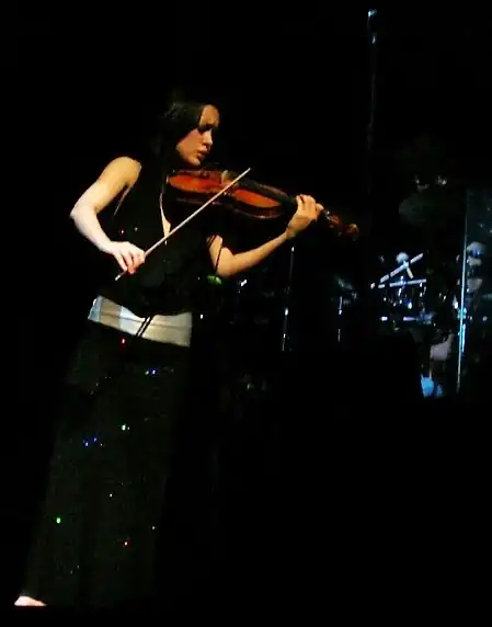 Micarelli playing the violin during Josh Groban's 2007 concert in the Palais des Congrès, in Paris.