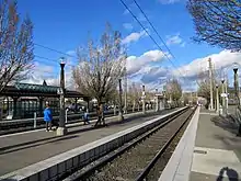People waiting on a light rail platform