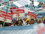 Image 34Union members march in Argentina on Human Rights Day in December 2005. The signs read "Worker rights are human rights..