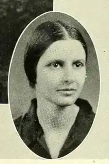 A white woman with dark hair parted in the center