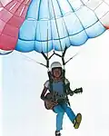 Masayoshi Takanaka parachuting with his guitar