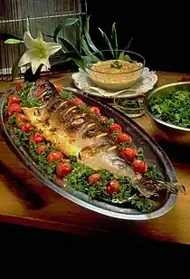 Image 33Masghouf fish, one of Iraq's national dishes, a Mesopotamian cuisine dating back to ancient times, typically fish caught from the rivers of Euphrates and Tigris, and grilled near the river bed (from Culture of Iraq)