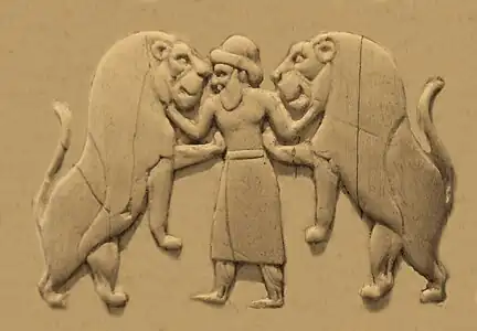 Master of animals, wearing a long skirt and trousers, as well as a brimmed hat (Back, 1st register).